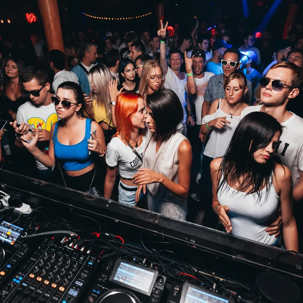Guests at the DJ booth during a night event